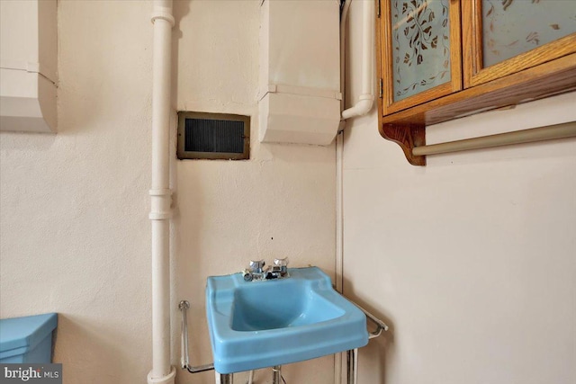 bathroom featuring visible vents and a sink