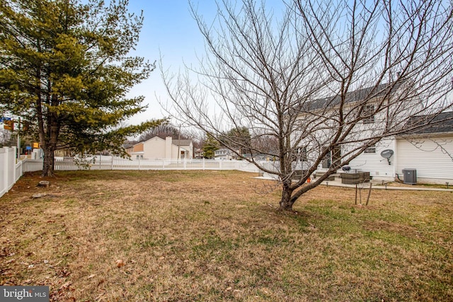 view of yard with central air condition unit and fence private yard