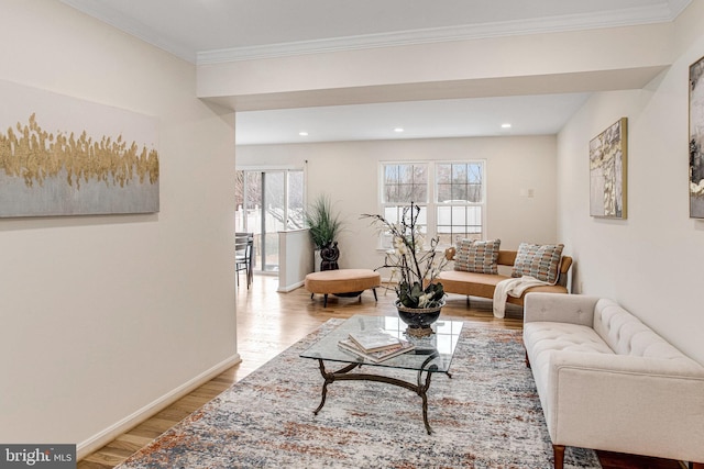 living room featuring recessed lighting, baseboards, ornamental molding, and light wood finished floors