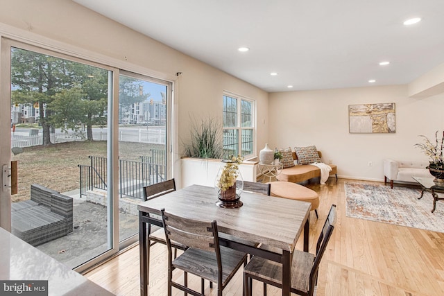 dining area with recessed lighting, baseboards, and light wood finished floors