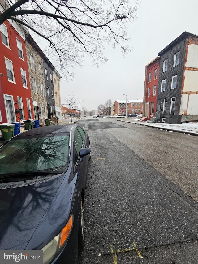 view of street with curbs, street lighting, and sidewalks