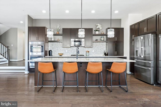 kitchen featuring open shelves, stainless steel appliances, dark brown cabinetry, and dark wood finished floors