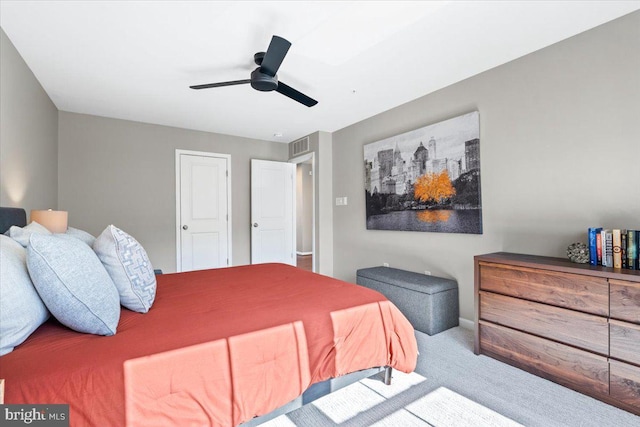 carpeted bedroom with visible vents and a ceiling fan