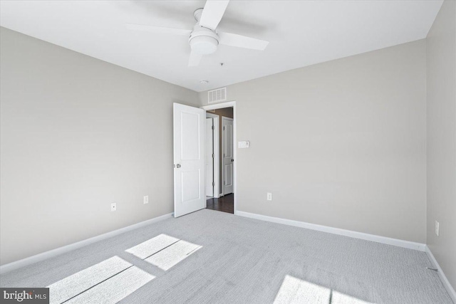 unfurnished bedroom featuring carpet flooring, baseboards, visible vents, and ceiling fan