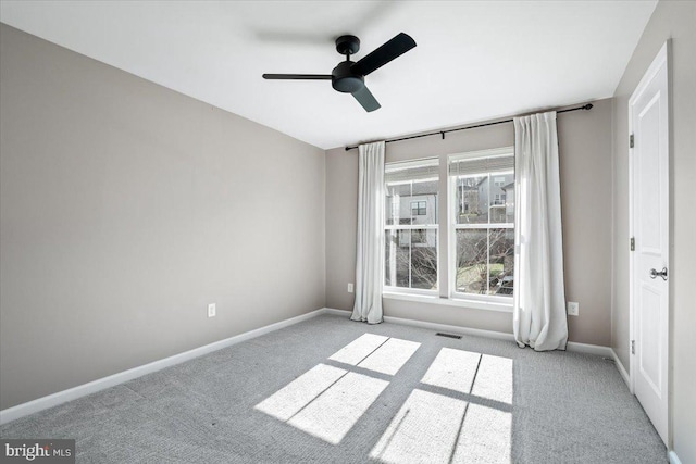 spare room featuring visible vents, baseboards, and carpet floors