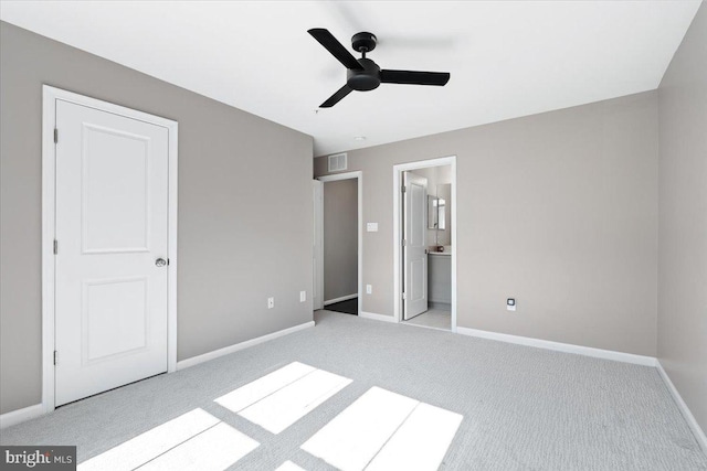 unfurnished bedroom with visible vents, ensuite bathroom, carpet flooring, baseboards, and ceiling fan