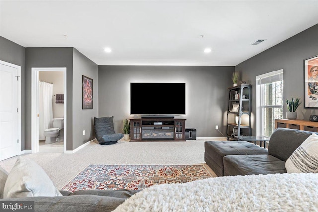 carpeted living room with recessed lighting, visible vents, and baseboards