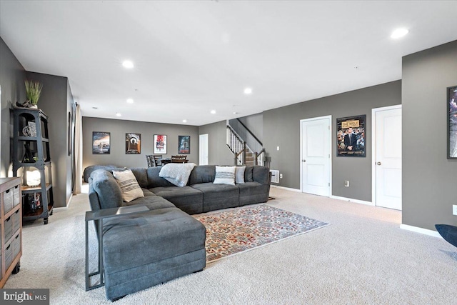 living area with recessed lighting, light colored carpet, stairs, and baseboards