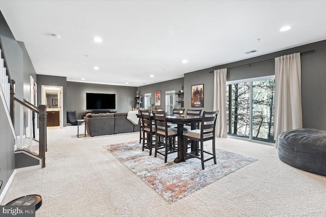 dining space featuring visible vents, light carpet, recessed lighting, stairway, and baseboards