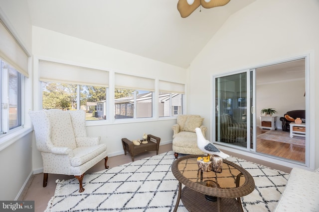 sunroom with a healthy amount of sunlight, ceiling fan, and vaulted ceiling