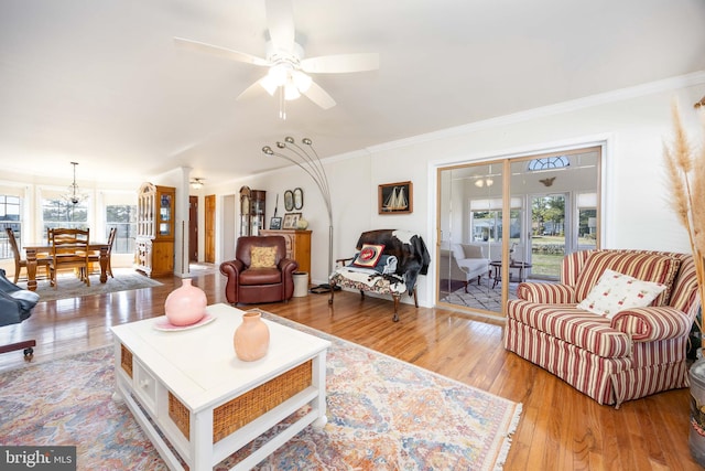 living room featuring a wealth of natural light, ornamental molding, a ceiling fan, and hardwood / wood-style flooring