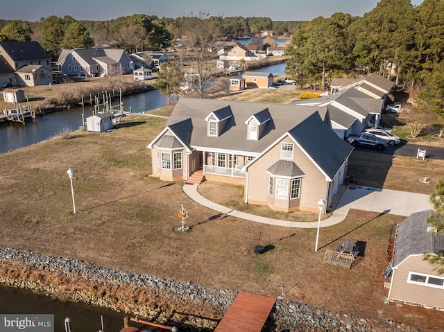 bird's eye view with a residential view and a water view