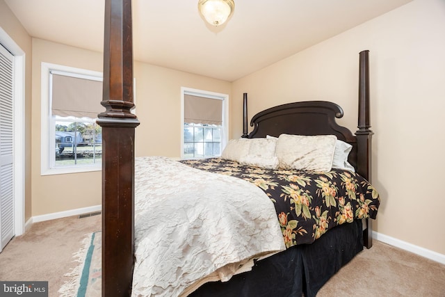 carpeted bedroom with visible vents and baseboards