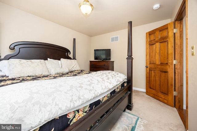 bedroom with light carpet, visible vents, and baseboards