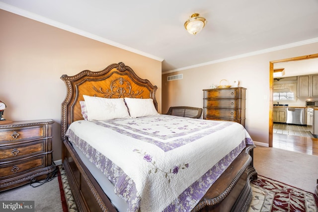 bedroom featuring visible vents, ornamental molding, and carpet flooring