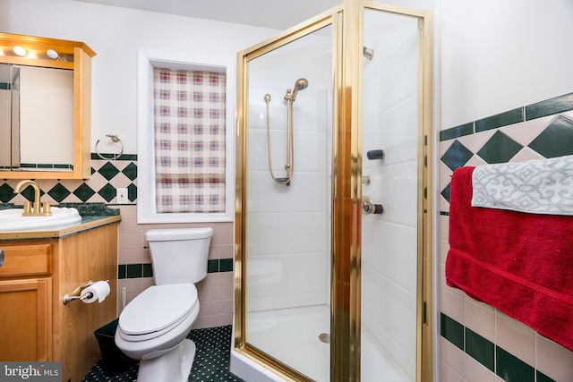 full bath featuring vanity, toilet, tile walls, and a shower stall