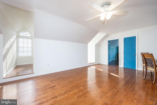 additional living space featuring ceiling fan, baseboards, lofted ceiling, and hardwood / wood-style floors