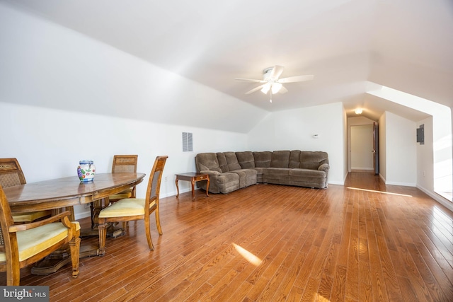 dining room with light wood finished floors, visible vents, ceiling fan, baseboards, and lofted ceiling