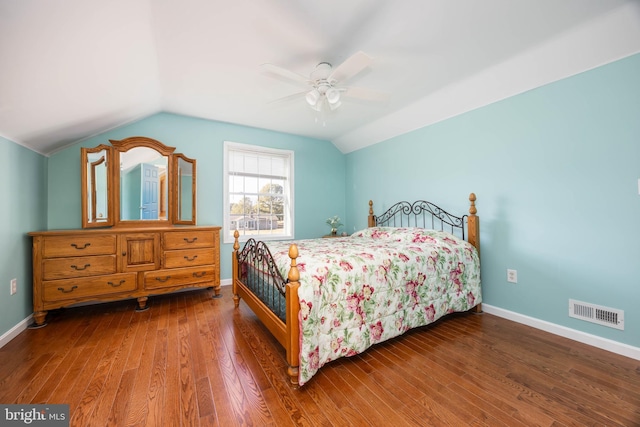 bedroom with visible vents, baseboards, vaulted ceiling, wood finished floors, and a ceiling fan