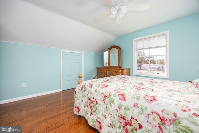 bedroom with a ceiling fan, lofted ceiling, baseboards, and wood finished floors