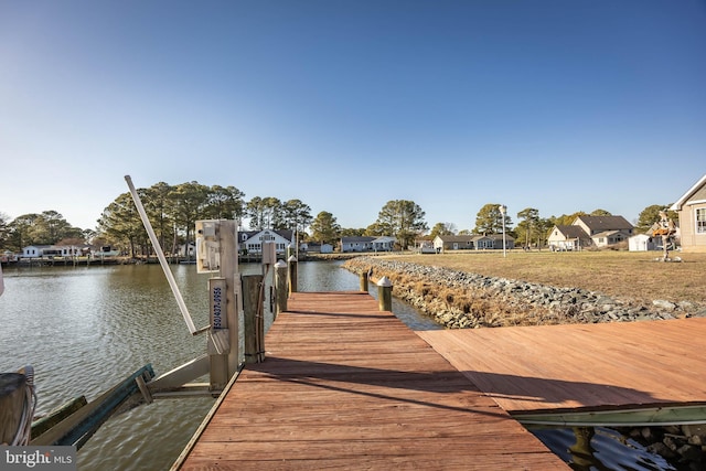 view of dock featuring a residential view and a water view