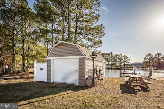 garage with a water view and a storage shed