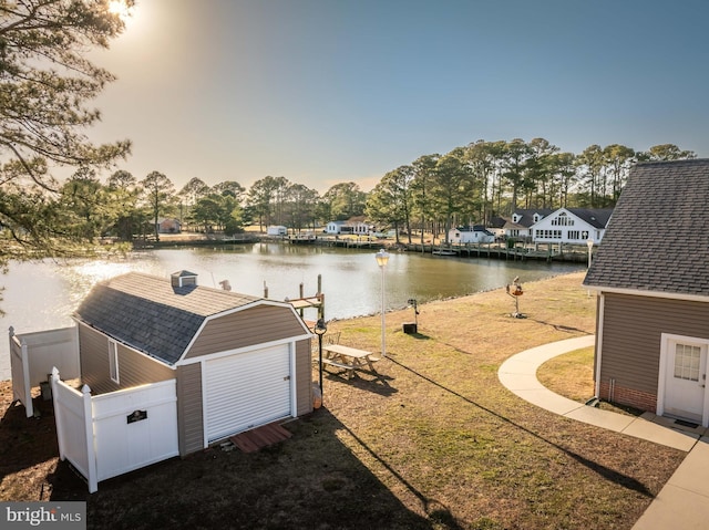 exterior space with a water view and fence