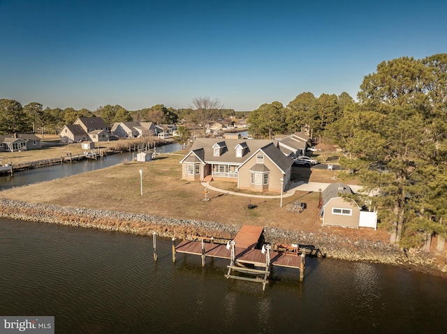 birds eye view of property with a residential view and a water view