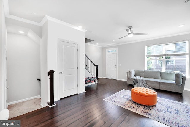 living room with stairway, hardwood / wood-style flooring, and crown molding