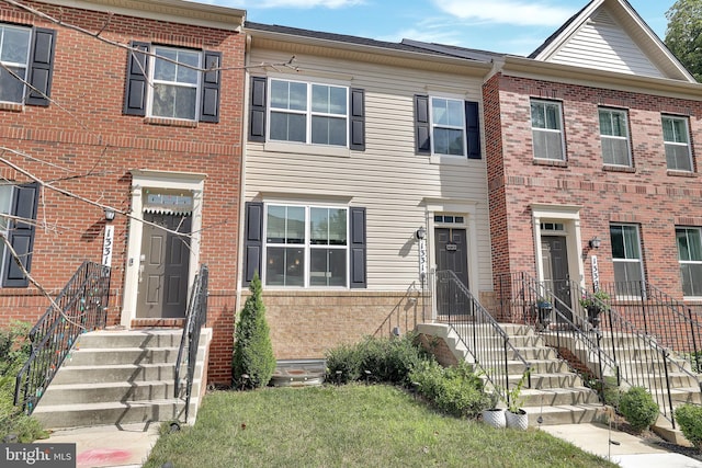 townhome / multi-family property with brick siding