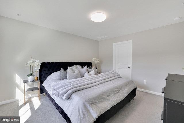 bedroom featuring baseboards and light colored carpet