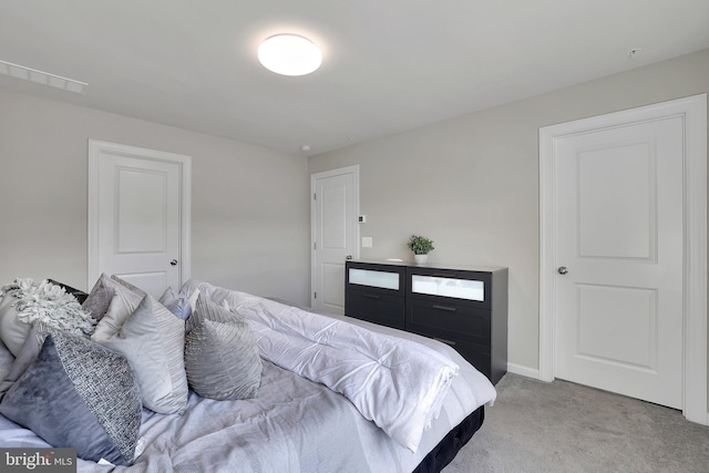 bedroom with light carpet and baseboards