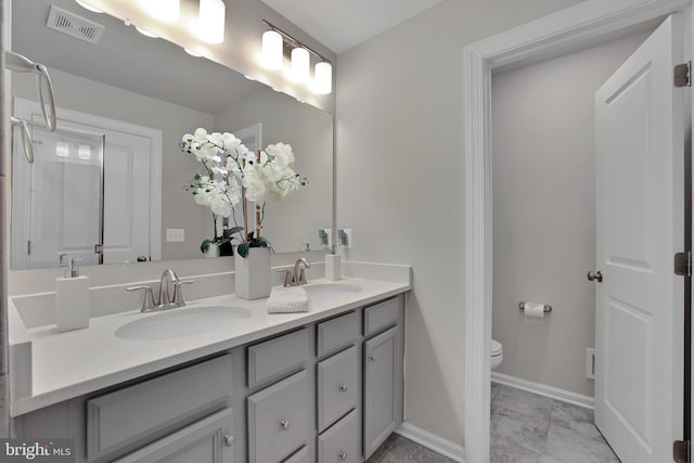 full bath with marble finish floor, visible vents, a sink, and toilet