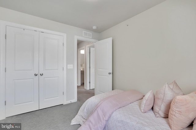 bedroom featuring a closet, carpet, and visible vents