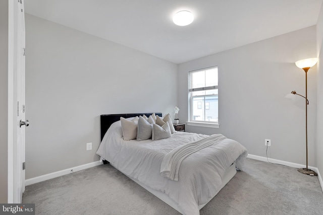 carpeted bedroom featuring baseboards