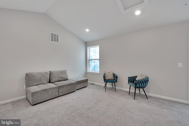 sitting room featuring lofted ceiling, carpet flooring, visible vents, and baseboards