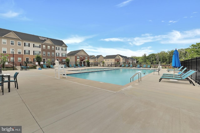 community pool featuring a patio area and fence