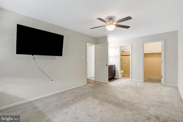 13498 Keytone Rd, Woodbridge, VA 22193 - unfurnished bedroom with baseboards, a walk in closet, light carpet, and connected bathroom