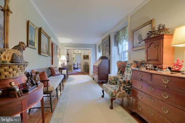 corridor featuring light wood finished floors and ornamental molding