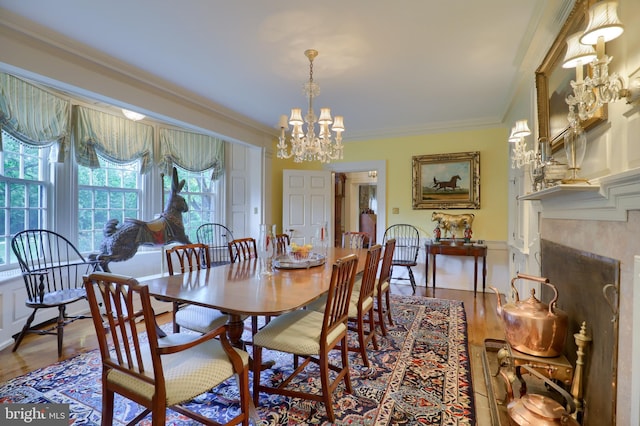 dining space featuring a chandelier, crown molding, and wood finished floors