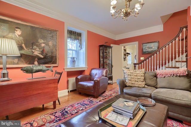 living room featuring stairs, wood finished floors, radiator heating unit, and ornamental molding