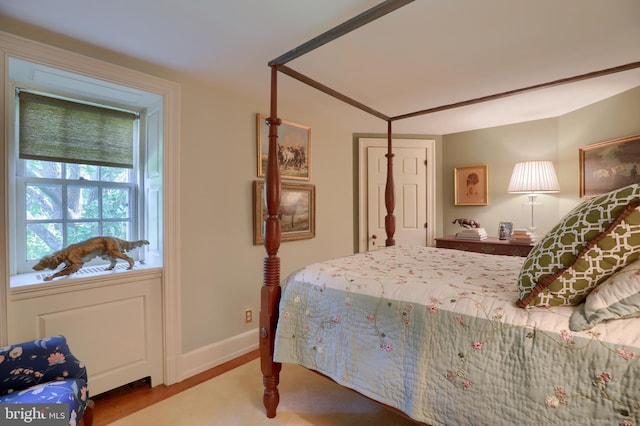 bedroom with wood finished floors and baseboards