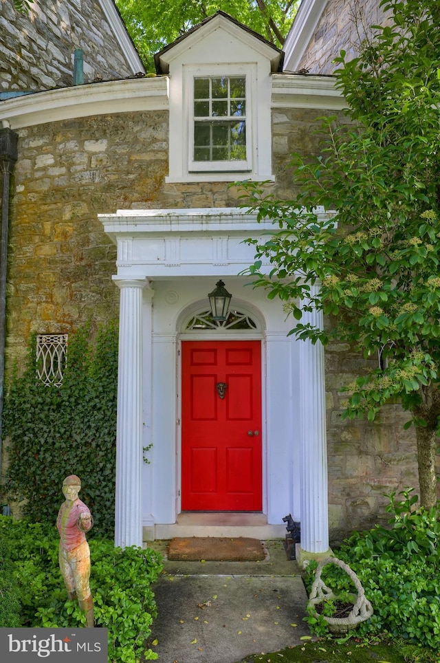 view of exterior entry featuring stone siding