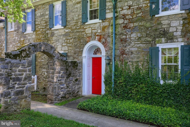 view of exterior entry featuring stone siding