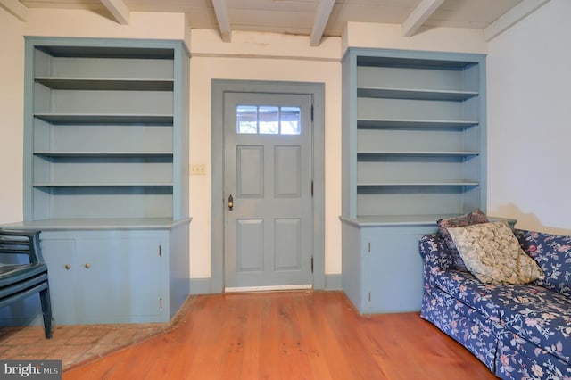 entryway featuring beam ceiling and wood finished floors