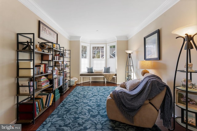 living area with baseboards, wood finished floors, and crown molding