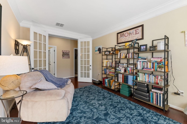 sitting room with french doors, visible vents, ornamental molding, wood finished floors, and baseboards