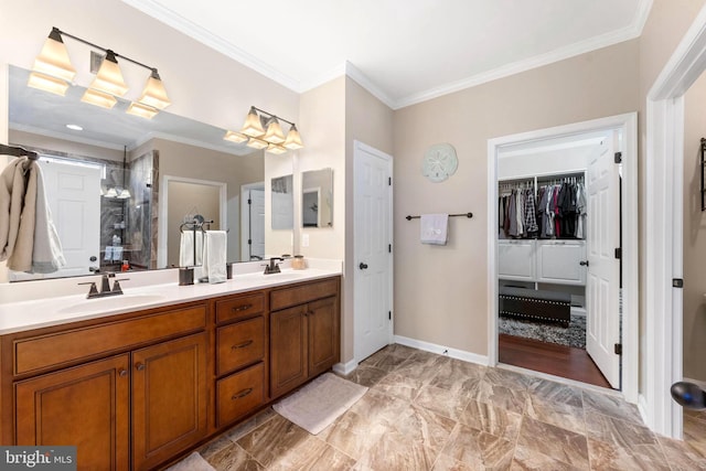 full bathroom featuring double vanity, a shower stall, crown molding, and a sink