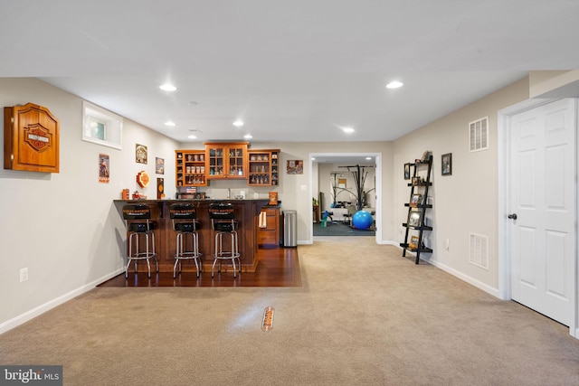 bar featuring carpet, wet bar, and visible vents