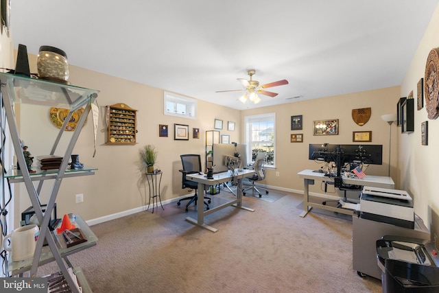 office featuring a ceiling fan, carpet, visible vents, and baseboards